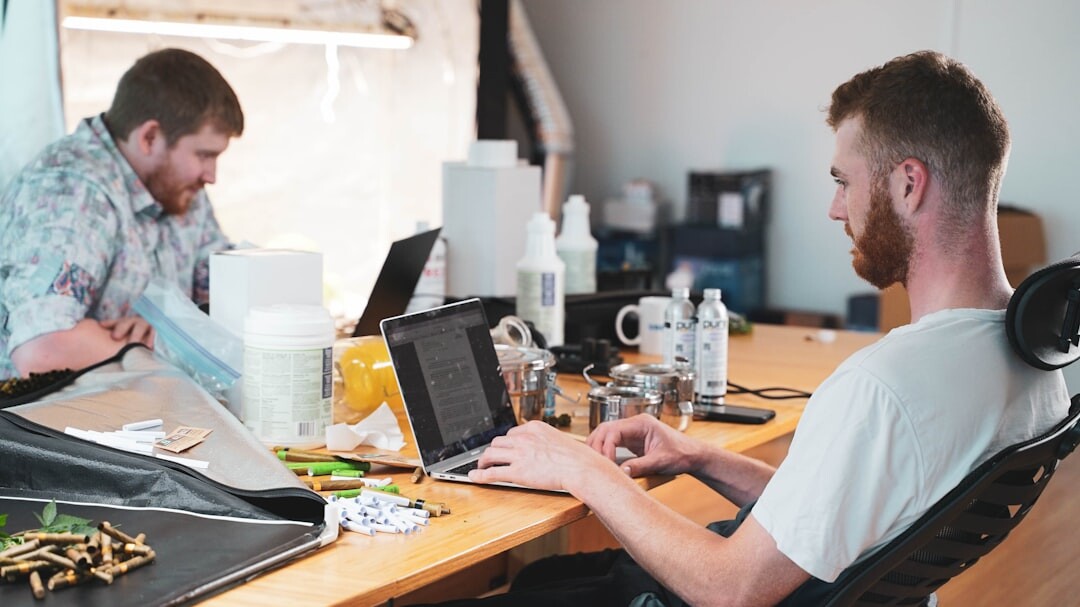 Diverse tech team working together around a conference table with laptops