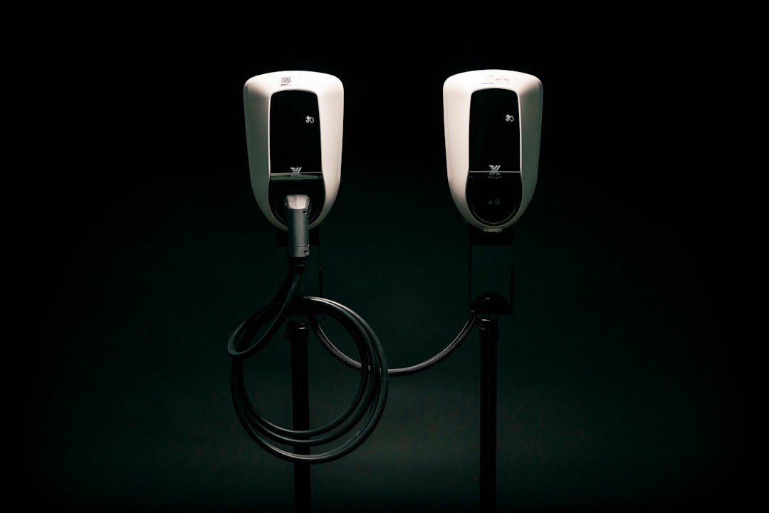 Electric vehicle charging at a modern charging station at night