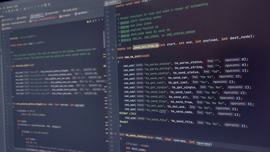 Developer coding on multiple monitors with code visible on screen