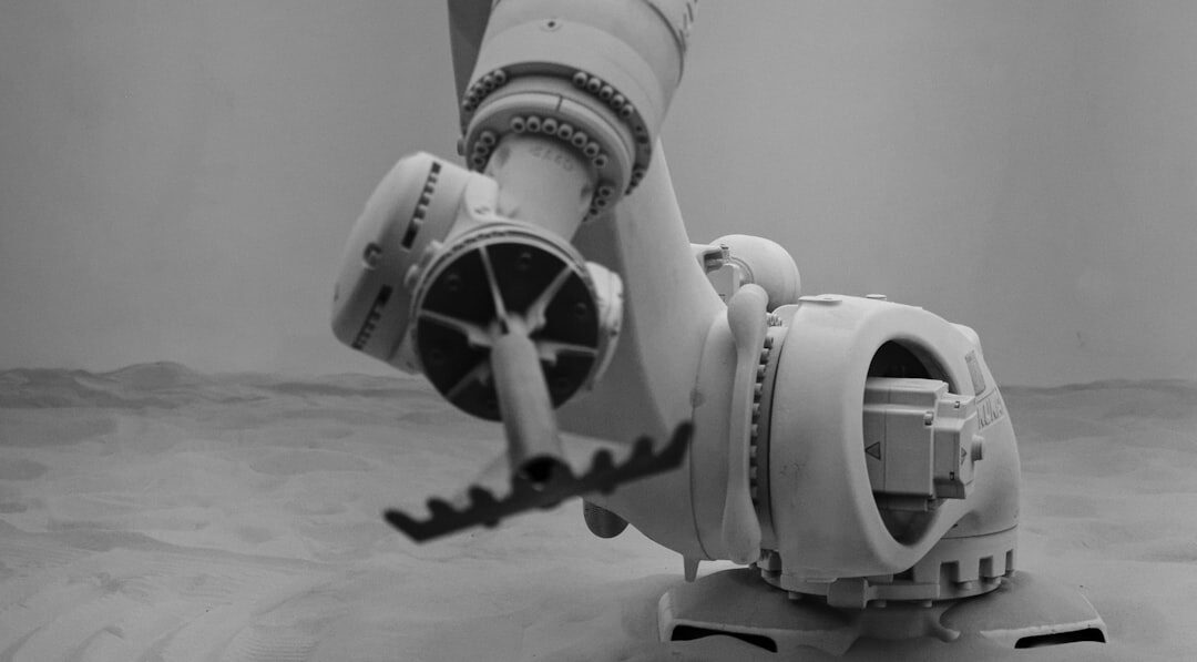Modern white robot arm in industrial factory setting
