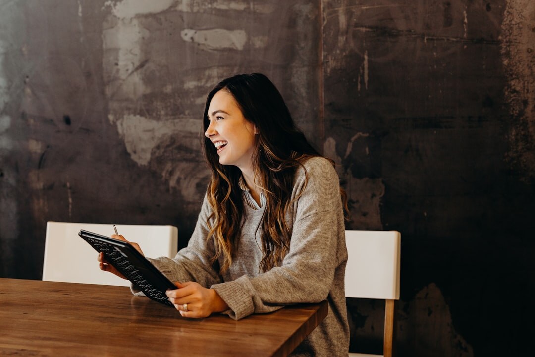 Person reading technology news on tablet with coffee